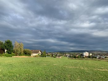 Houses on field against sky