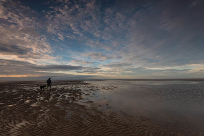 Scenic view of beach against sky during sunset