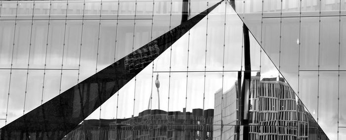 Low angle view of bridge against buildings in city