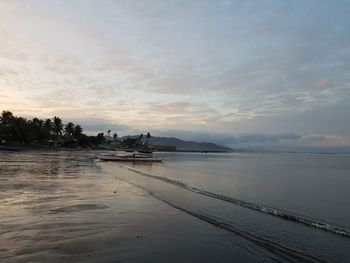 Scenic view of beach against sky during sunset