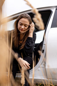 View of young woman sitting in car