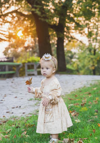 Portrait of cute girl standing on field