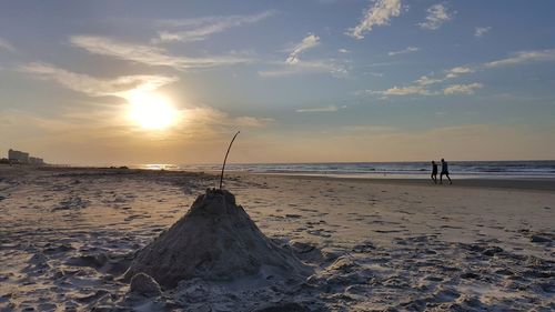 Scenic view of beach against sky during sunset