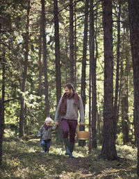 Father walking with son through forest