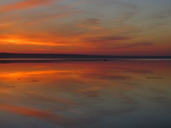 Scenic view of lake against romantic sky at sunset