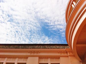 Low angle view of building against cloudy sky