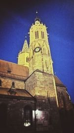 Low angle view of bell tower against blue sky