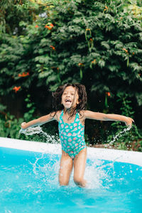 Portrait of young woman swimming in pool