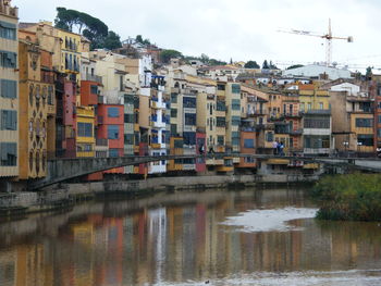 Reflection of buildings in river against sky