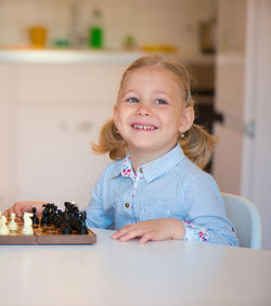 Cute smiling girl sitting at home