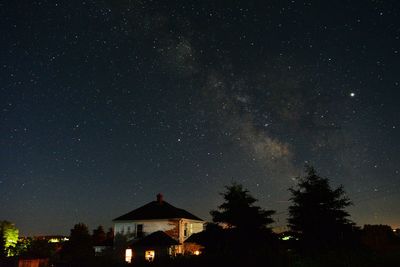 Illuminated building against sky at night