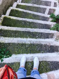 Low section of man standing on steps