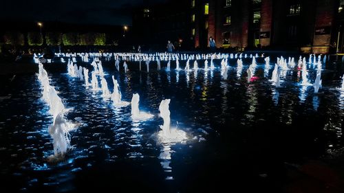 Illuminated swimming pool at night