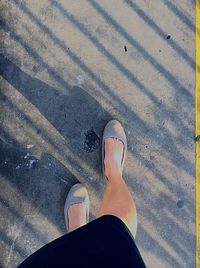 Low section of woman standing on tiled floor