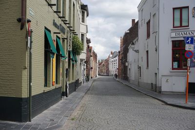 Street amidst buildings against sky