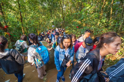 Group of people against plants