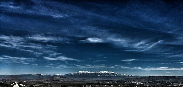 Scenic view of landscape against cloudy sky