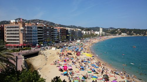 High angle view of people on beach against clear sky