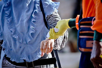 Midsection of couple holding hands