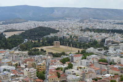 Aerial view of cityscape against mountains