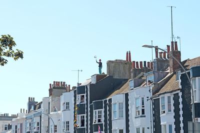 Buildings against clear blue sky