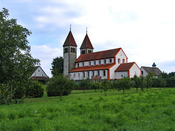 Building on field against sky