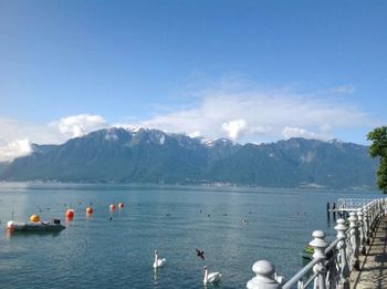 Scenic view of lake and mountains against sky