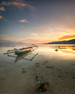 Scenic view of beach against sky during sunset