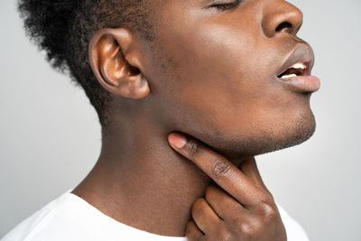 Close-up portrait of mid adult man over white background