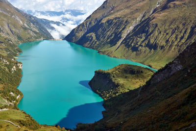 Scenic view of lake and mountains against sky