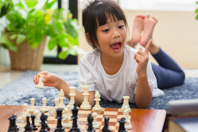 Girl playing chess at home