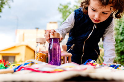 Cute girl playing with bottles