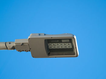 Low angle view of floodlight against clear blue sky