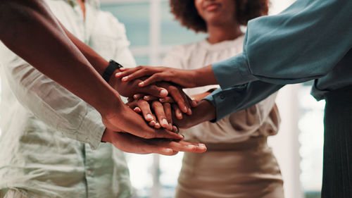 Midsection of business people shaking hands