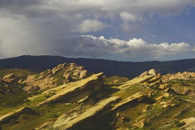 Scenic view of mountains against cloudy sky