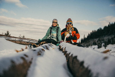 People on snow covered mountain against sky