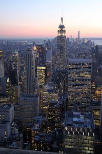 Aerial view of city lit up at sunset