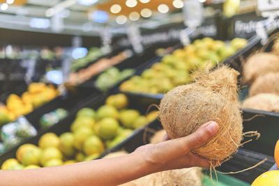 Close-up of hand holding fruits at market stall