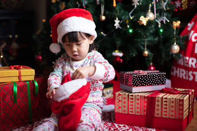 Cute girl holding christmas stocking