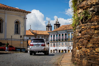 Street amidst buildings in city against sky