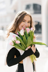 Young woman holding flower