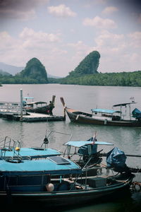 Boats moored in sea against sky