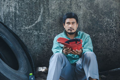 Portrait of young man sitting outdoors