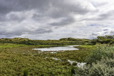 Dunes nature reserve egmond - scenic view of lake against sky