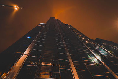 Low angle view of illuminated buildings against sky at night