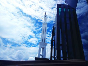 Low angle view of building against cloudy sky