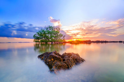 Scenic view of lake against sky during sunset