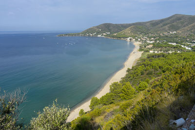 High angle view of sea and mountains against sky