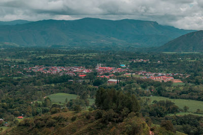 High angle view of townscape and mountains against sky