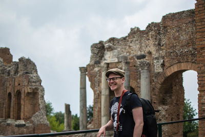 Portrait of man standing in front of historical building